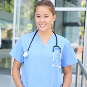 female medical professional smilling in scrubs