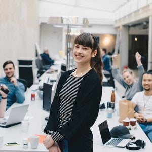 Designers looking at the camera in a meeting room