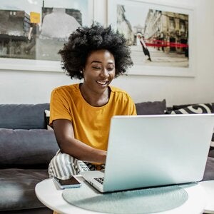 female writer smiling at laptop