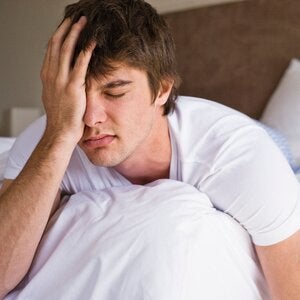 man in bed frustrated by a lack of sleep