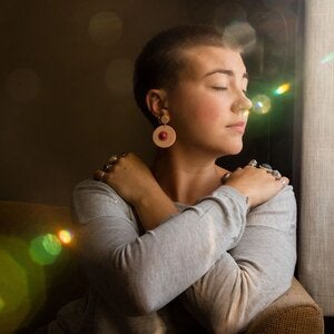 woman hugging herself with rays of sunlight